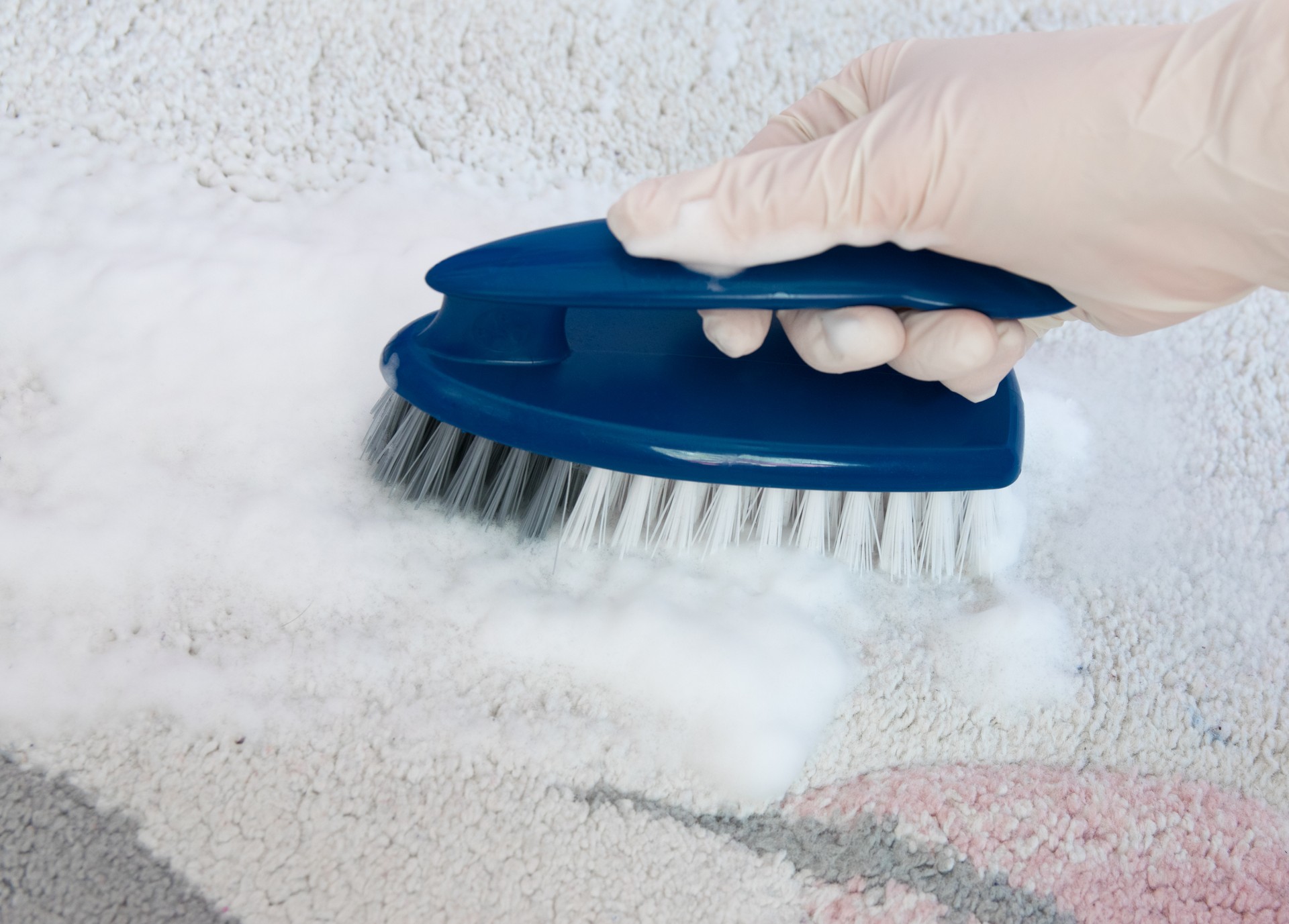 Blue brush with hand on the floor. Cleaning.